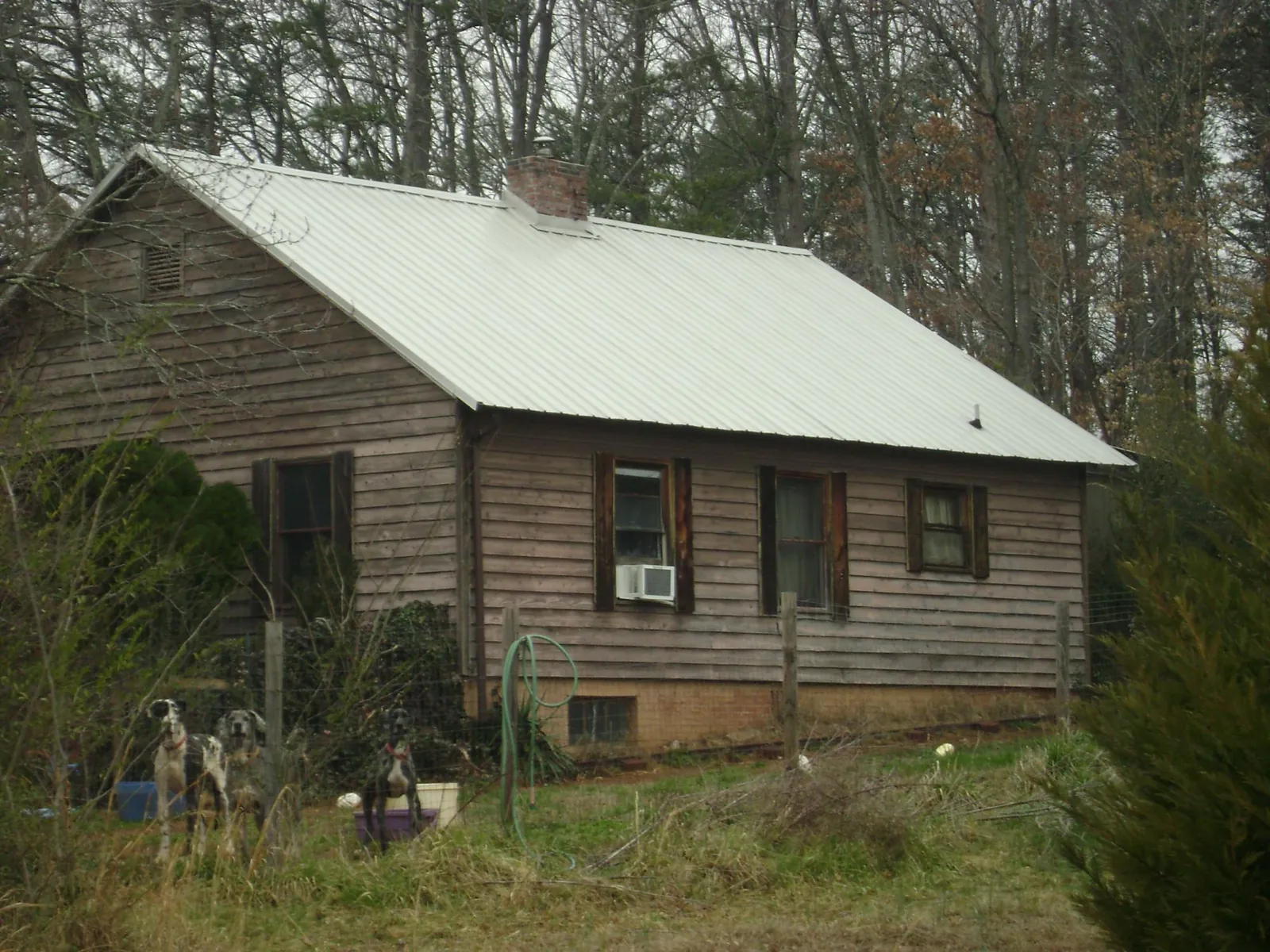 White metal roof on an old wood sided farmhouse, from a Asphalt Shingle Roof Repair job in Roxbury
